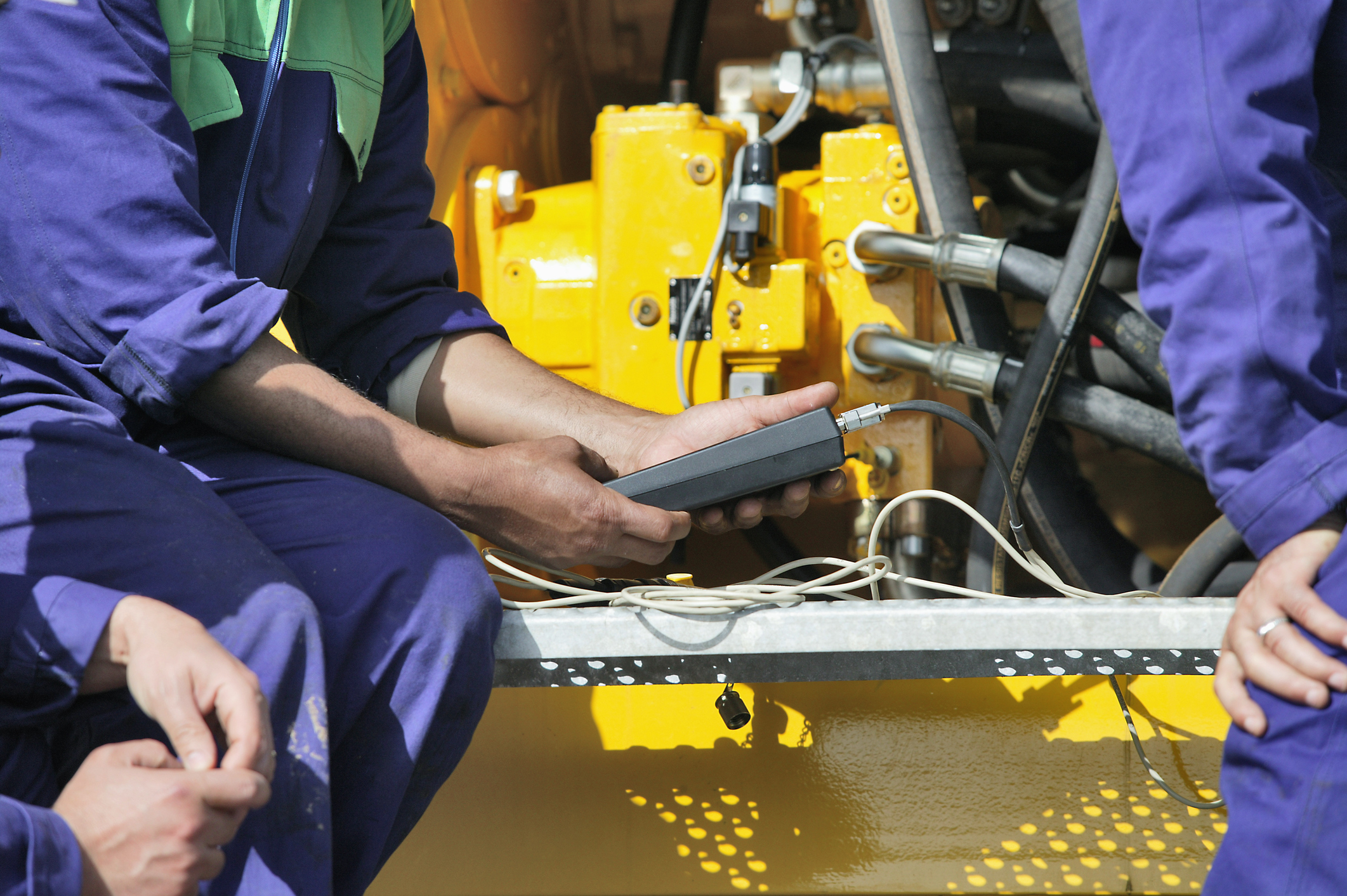 Technician performing periodic engine maintenance