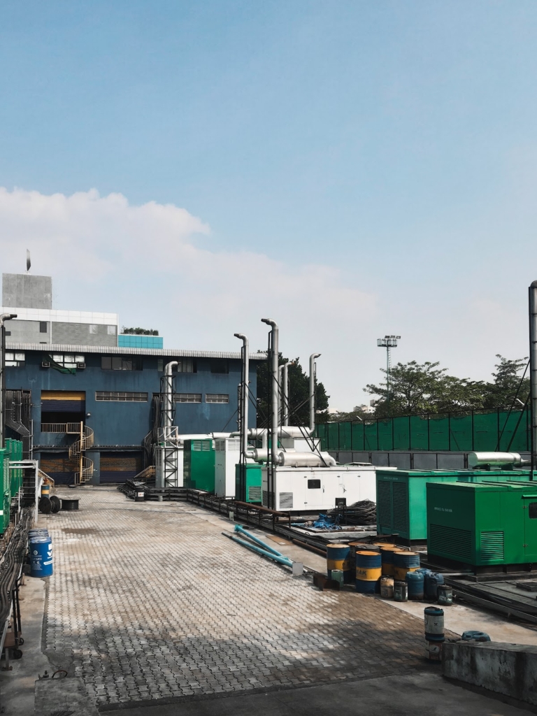  A group of diesel generators outside an industrial establishment. 